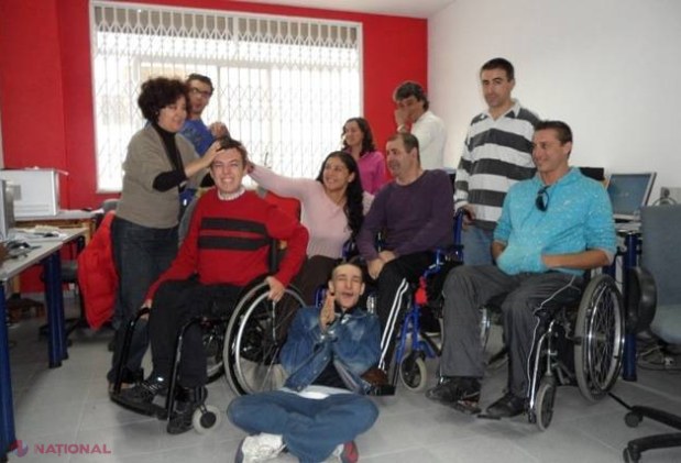 Patru limbi şi design grafic dintr-un scaun cu rotile